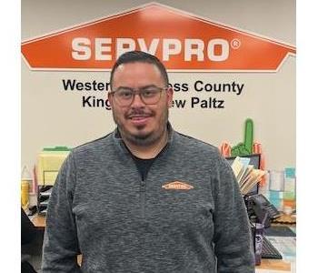 A photo of a smiling male employee wearing glass and a SERVPRO shirt.