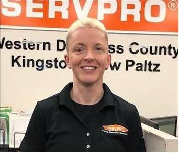 A photo of a smiling female SERVPRO employee wearing a SERVPRO shirt